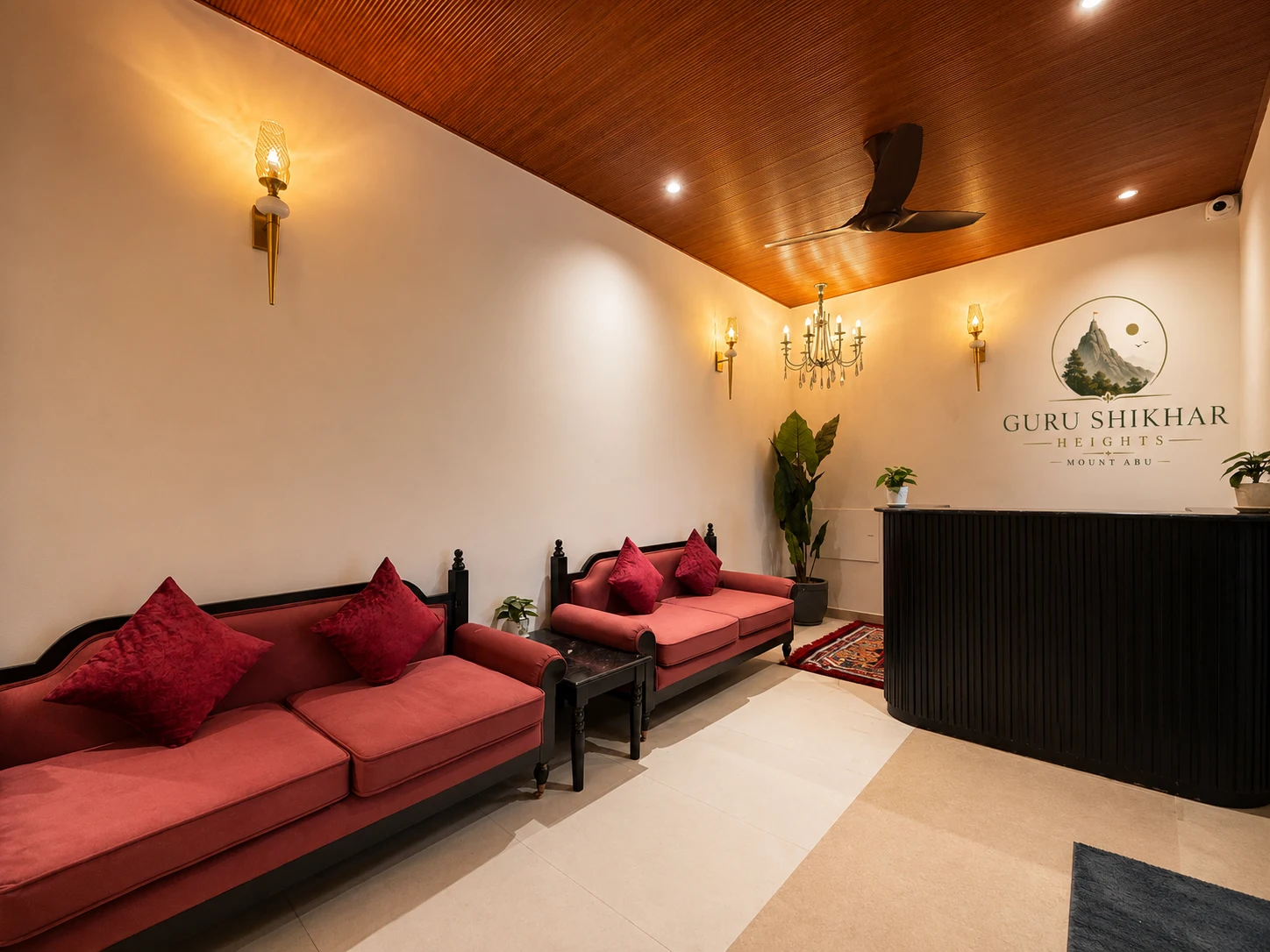 The reception lounge with the Guru Shikhar Heights logo wall